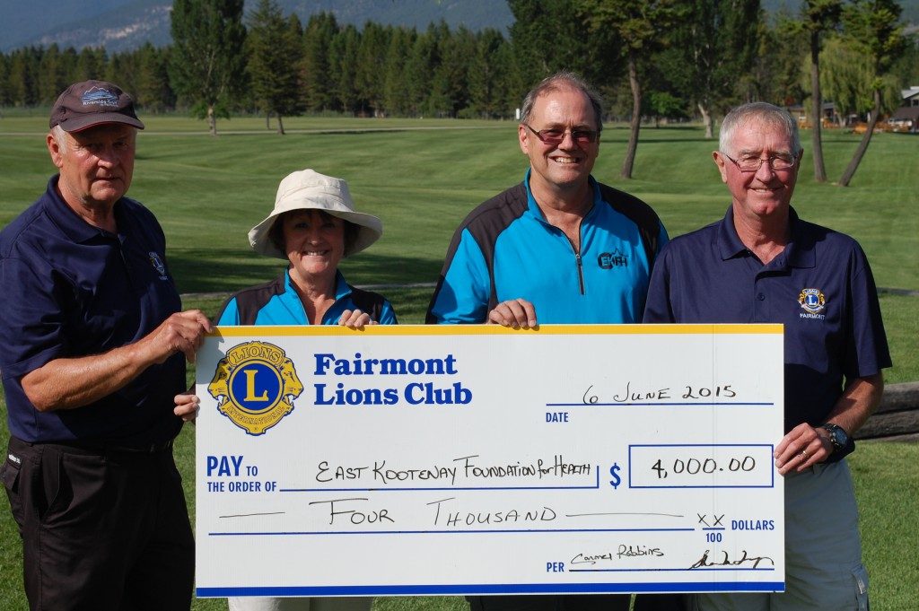  Photo details:  Lions members Norbert Schab, Tournament Chair (left) and Mike Tanguay, 1st Vice-President (right) present $4,000 to EKFH’s Donna Grainger & Doug Frioult (photo compliments of Dean Midyette, Columbia Valley Pioneer) 